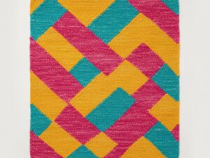 Vibrant accent rug with bold yellow, pink, and teal patterns.