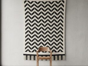 Monochrome black and white chevron pattern rug hanging as a wall tapestry.
