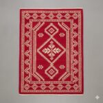 Bold accent rug with a vibrant crimson red background and cream-white traditional motifs.