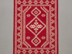 Bold accent rug with a vibrant crimson red background and cream-white traditional motifs.