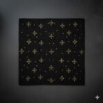 An elegant black accent rug with scattered, shimmering gold star-like geometric motifs.