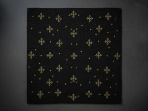 An elegant black accent rug with scattered, shimmering gold star-like geometric motifs.