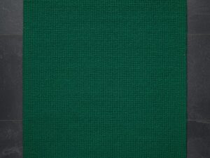 A luxurious, deep emerald green accent rug with a subtle textured pattern.