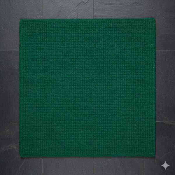 A luxurious, deep emerald green accent rug with a subtle textured pattern.