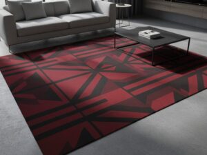 A dramatic and bold area rug with crimson red and charcoal black geometric patterns.