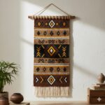 A wall tapestry featuring bold, ethnic tribal patterns in earthy brown, black, and ochre.