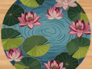 A round accent rug with a water lily design in shades of pink, green, and blue.